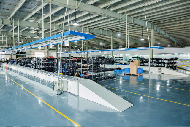 Inside view of Linbo Transportation Tech's production workshop, featuring state-of-the-art equipment for electric vehicle manufacturing.