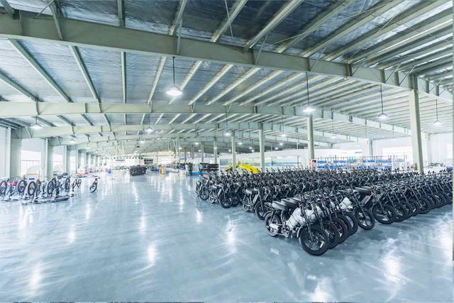 Wide-angle shot of the Linbo Transportation Tech warehouse with rows of completed e-bikes and e-scooters, ready for distribution.